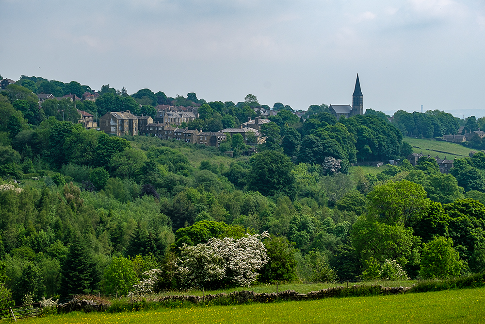 A distant view of the village of Haworth through the trees
