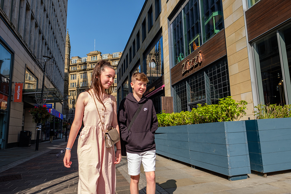 A young girl and boy on a shopping street