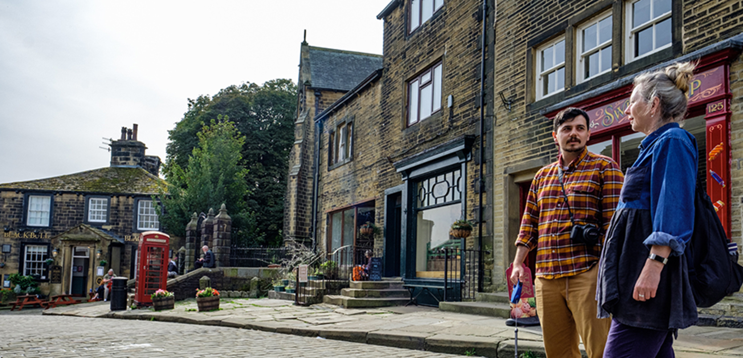 A man and woman on a cobbled street