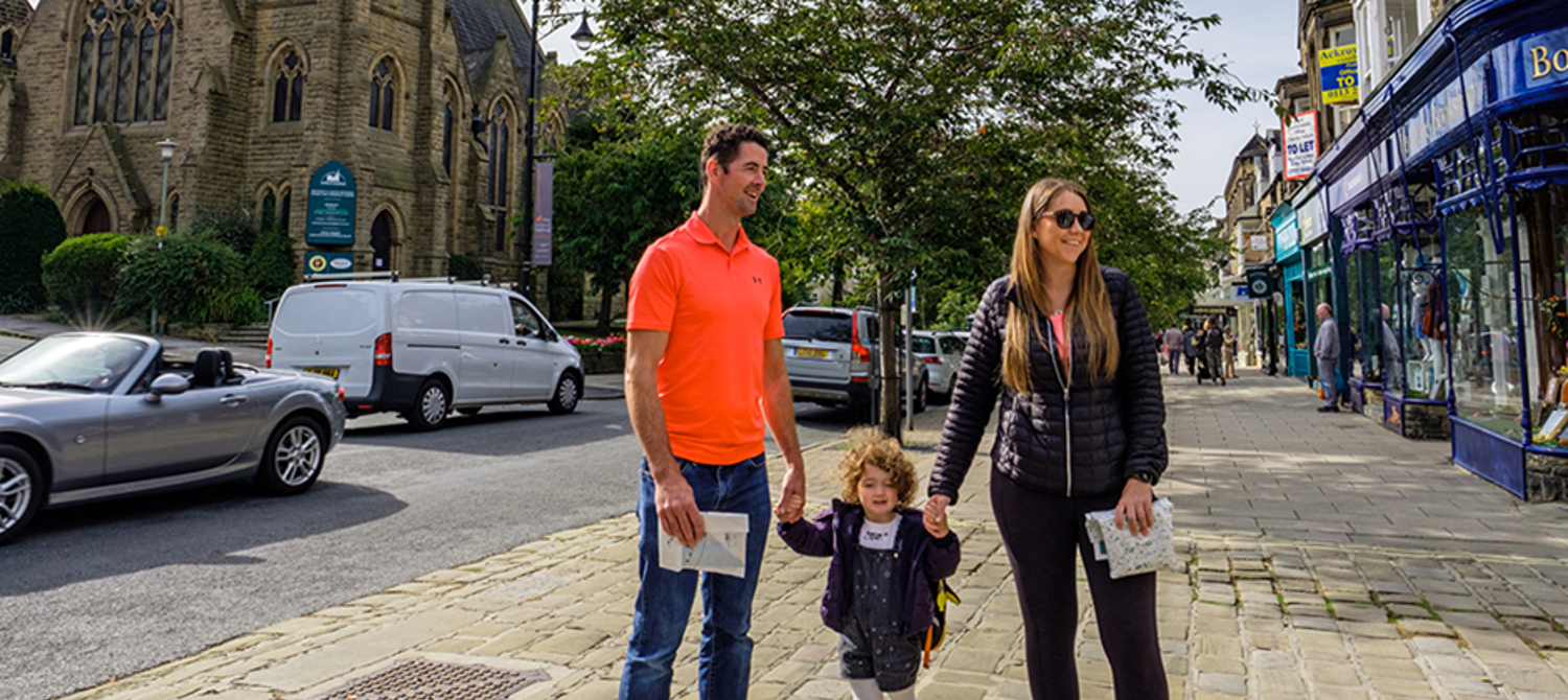 A man, woman and child on a high street